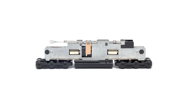 The Kato locomotive features a split die-cast metal frame that surrounds the flywheel-equipped motor.