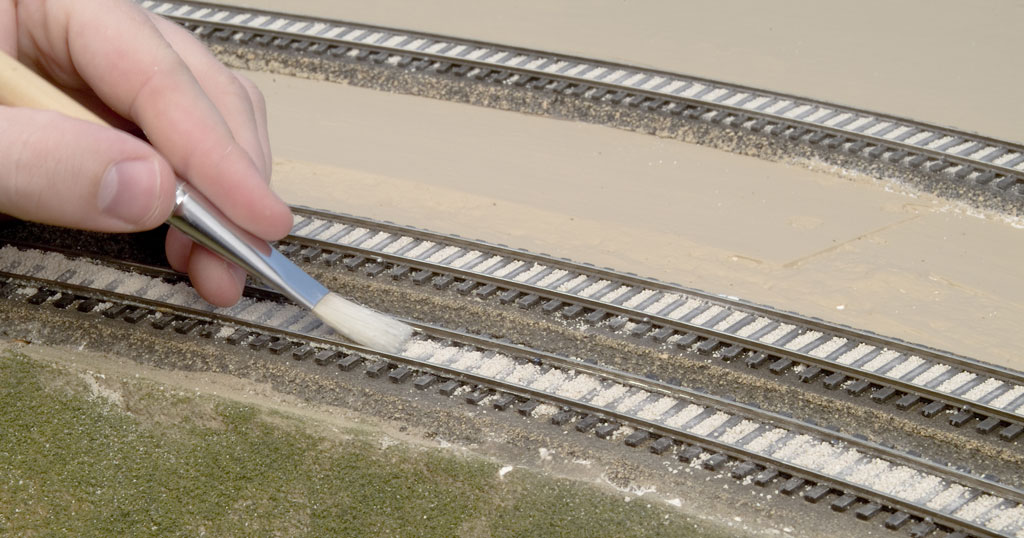 An image of a brush used on model railroad track.
