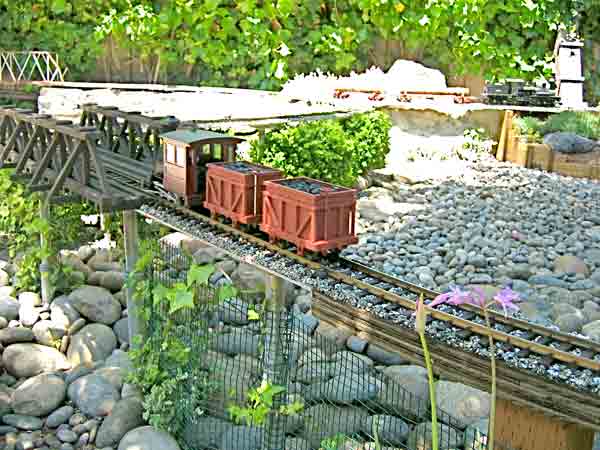 model train on raised track in garden railway