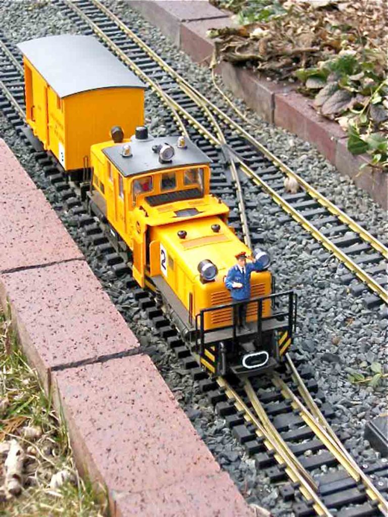 yellow track cleaning engine on track