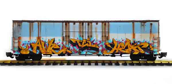 blue and white boxcar with graffiti