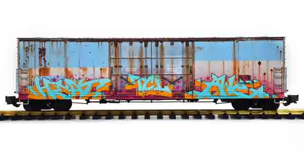 blue and white boxcar with graffiti
