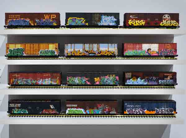 wall of model boxcars with graffit