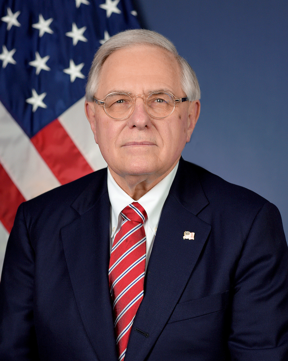 Man posed in front of U.S. flag