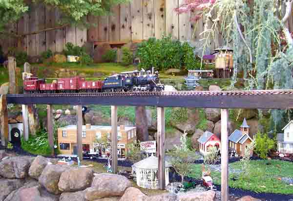 train on high bridge on garden railway