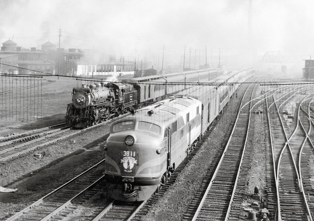 Boston & Maine 4-6-2 3664 on train 241 to Portsmouth, N.H., paces E7 3811 on train 147 to Portland, Maine, at Somerville, Mass., on Aug. 8, 1946.