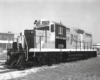 A black and white photo of a EMD locomotive sitting on the tracks