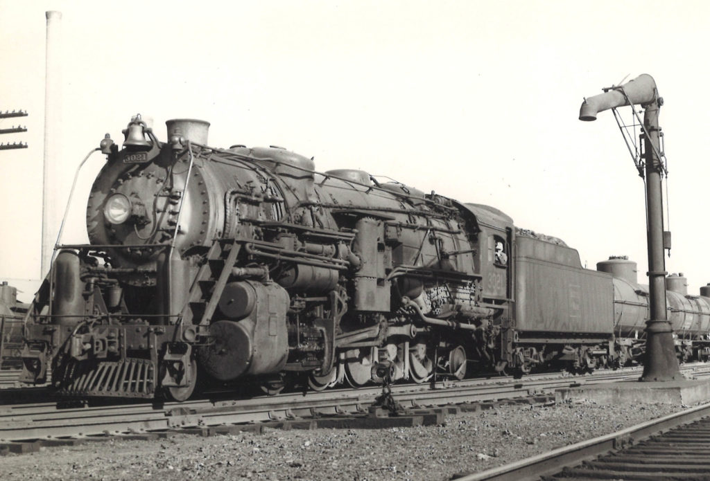 A close up black and white photo of the Boston & Maine Railroad 2-10-2 Santa Fe-type locomotive No. 3021 sitting on the tracks