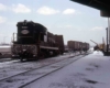 Black diesel locomotive with derailed train in snow