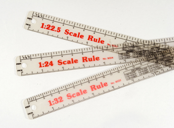 three scale rules on a table