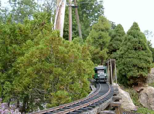 train approaching curve on garden railway