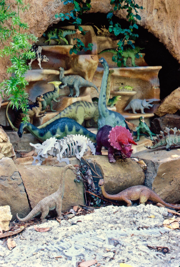plastic dinosaurs on a garden railway