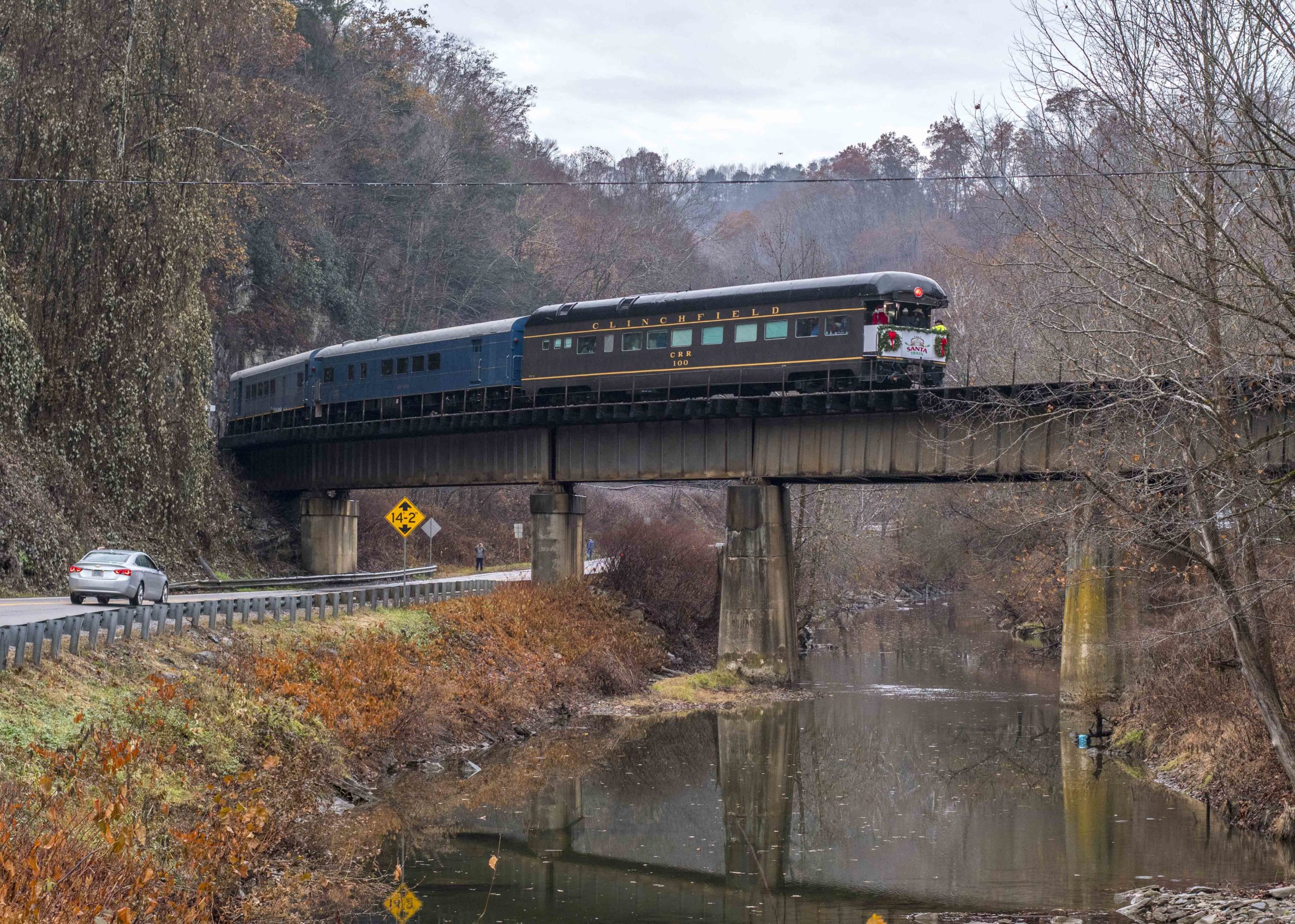 Business car at end of train crossing bridge