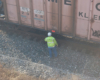 A worker walking up to a storage container