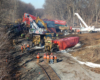 Workers using cranes to clean up containers