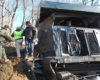 Three workers by a derailed train