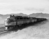 A black and white photo of a diesel locomotive on the tracks