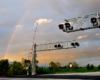 A rainbow over a railroad crossing