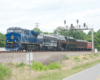 A train passing below a stoplight