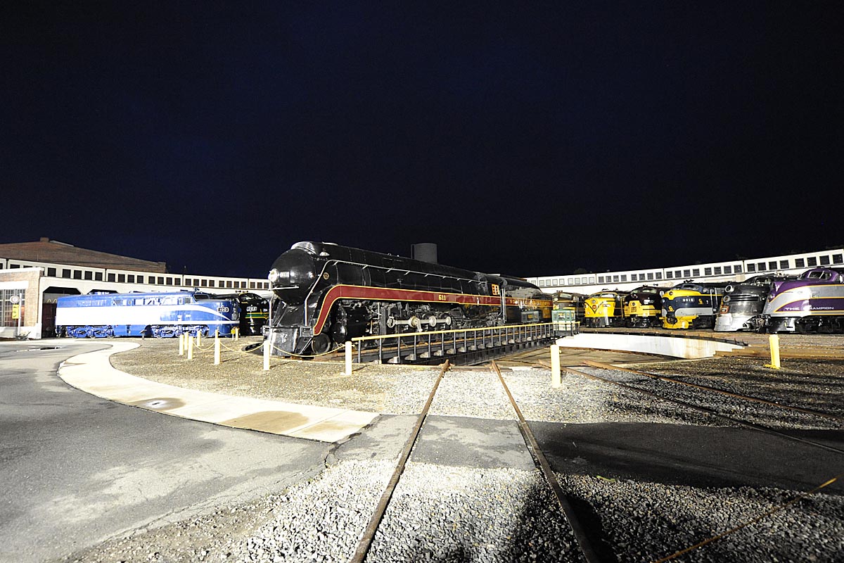 A black and red train on a turntable
