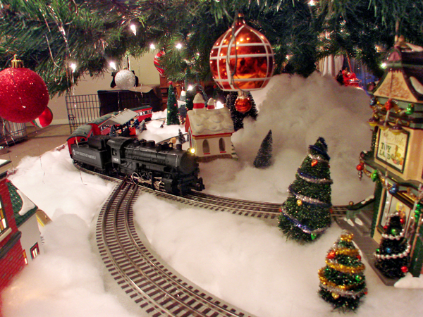 train on snow under Christmas tree