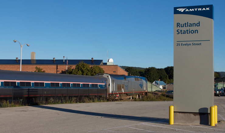 Passenger train with Rutland station sign in foreground