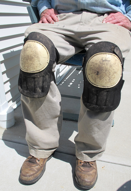 sitting person with knee pads on knees