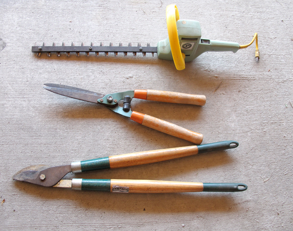 three garden tools on concrete