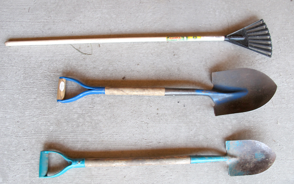 three shovels on concrete