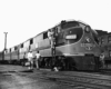 a diesel passenger train with a crew disembarking and embarking