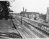 a passenger train by some buildings