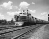 A black and white photo of a locomotive turning a corner