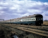 A train moving through a rural area