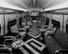 A black and white photo of the inside of an empty buffet car