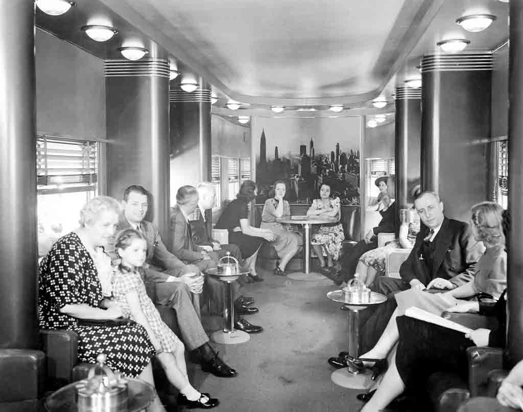 a group of people sitting around an observation car