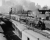 Steam passenger train departing a station