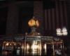 An information booth with a lit up clock over it