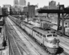 a diesel train departing a station in the background