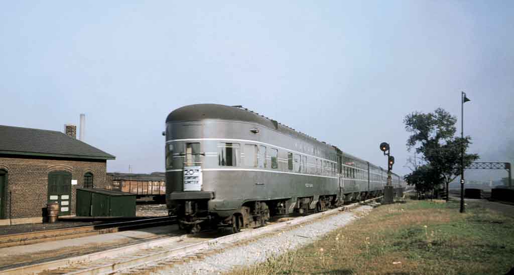 a passenger train in front of a station