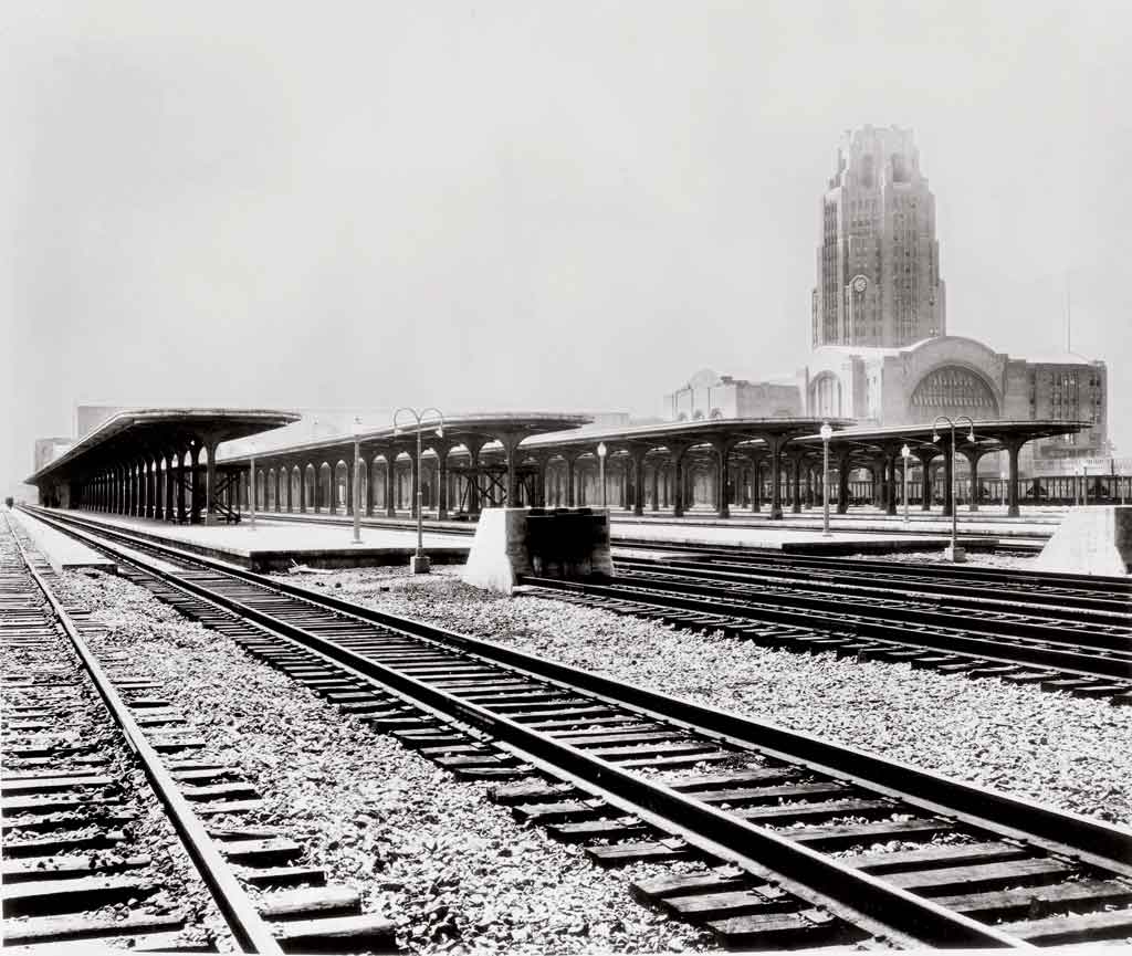 train platforms with a train station in the background