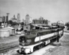 Diesel locomotives with passenger train by water spout