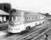 Streamlined motor car by station