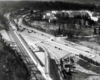 an aerial view of a train station and a large hotel in the background