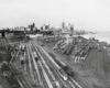 a large train yard with Detroit skyline in the background