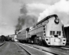 a streamlined steam locomotive pulling passenger cars