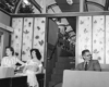 A black and white photo of two ladies and one gentleman sitting inside a dome car