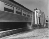 A black and white picture of a sunbeam car being washed by a machine