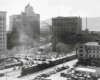 A black and white overhead picture of a locomotive passing through a city in Texas