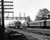 A black and white photo of two commuter trains passing each other