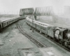 A black and white photo of two locomotives stemming off in different directions